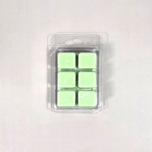 Clear 6-cavity clamshell packaging featuring vibrant light green soy wax melt cubes for home fragrance.