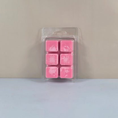 6-cavity clear plastic clamshell packaging filled with bright pink six-cube soy wax melts