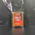 Wax melt package labeled 'Autumn Night' on a dark marble surface