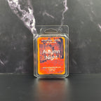 Wax melt package labeled 'Autumn Night' on a dark marble surface
