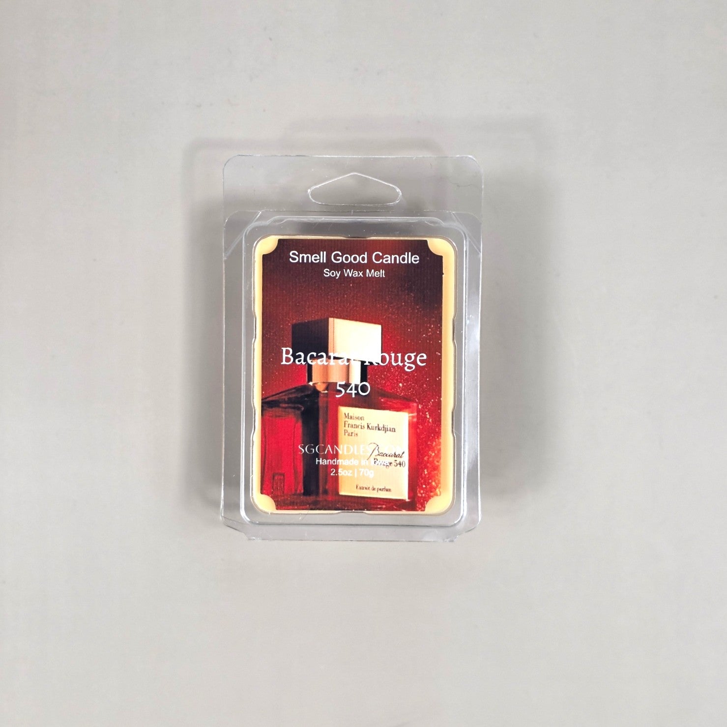 Labeled Baccarat Rouge 540 soy wax melt in a 2.5oz clamshell with a luxury red and gold label reflecting a high-end designer fragrance profile.