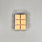 Clear 6-cube plastic clamshell packaging showcasing peach-colored soy wax melts for home fragrance.