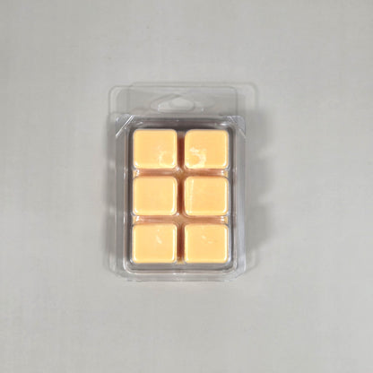 Clear 6-cube plastic clamshell packaging showcasing peach-colored soy wax melts for home fragrance.