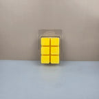 Pack of six yellow wax cubes in clear packaging on a neutral background