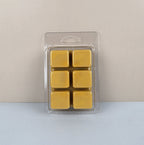 Pack of six yellow wax melts in a clear plastic packaging on a light gray background