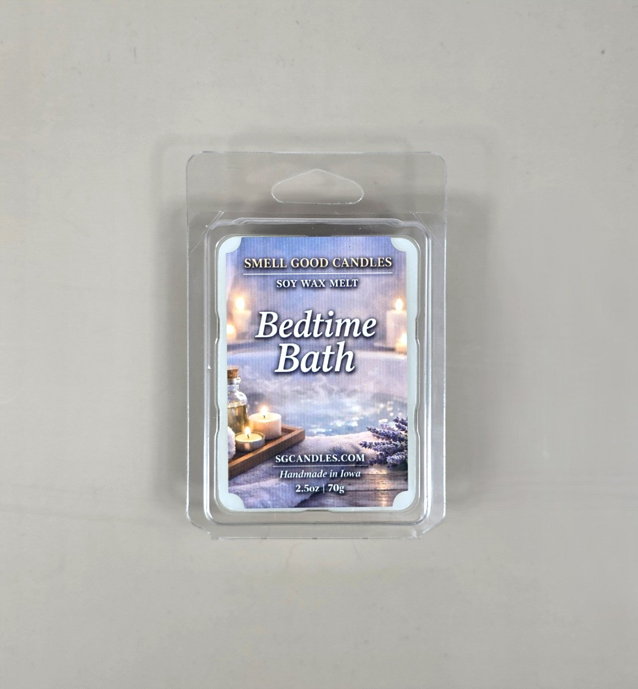 Top view of Bedtime Bath fragrance soy wax melt in a 2.5oz clear clamshell package featuring a relaxing label design with a bathtub, burning candles, and lavender flowers.