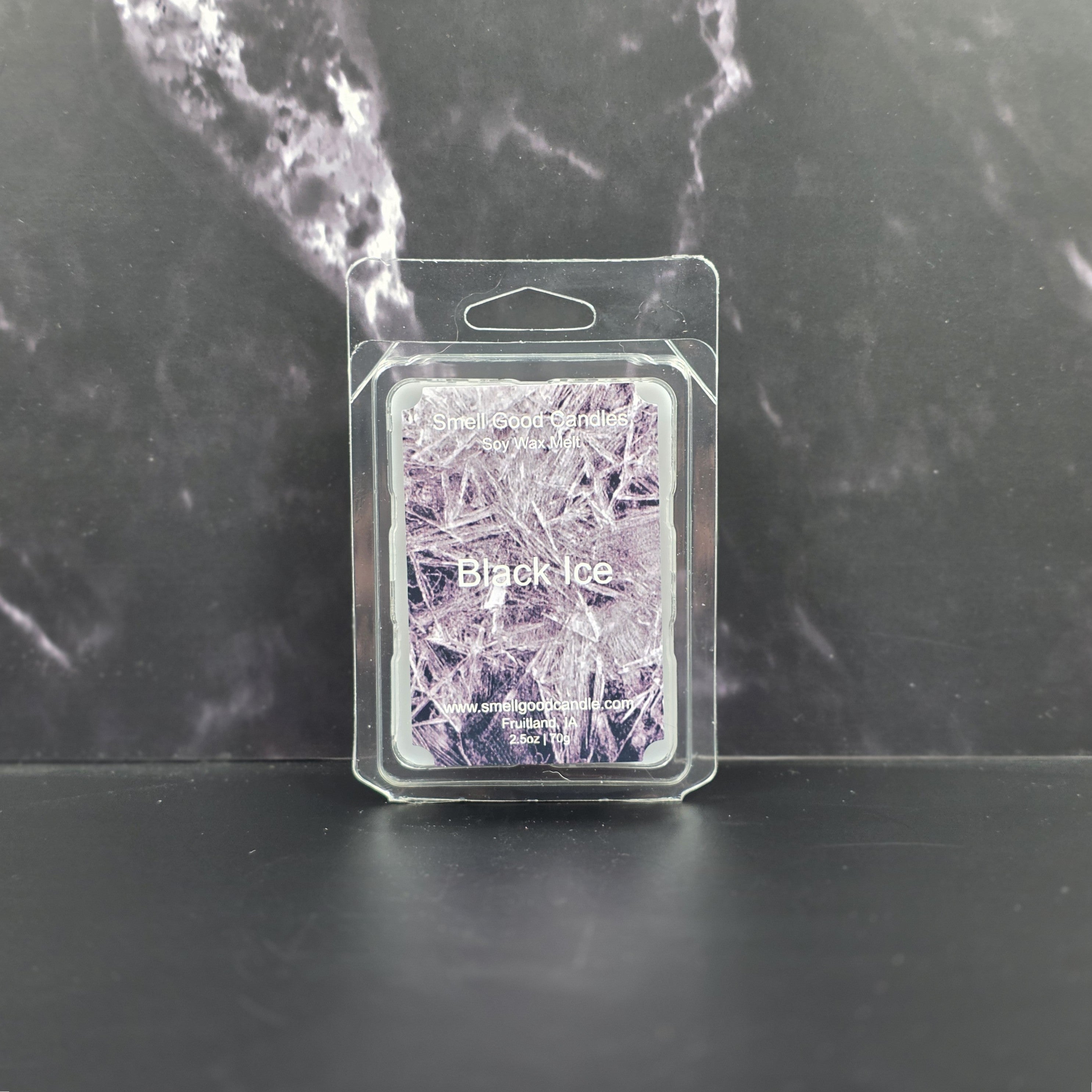 Packaged wax melt with 'Black Ice' design on a dark marble background