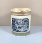 10oz glass jar candle with a black lid and a custom "Black Ice" label featuring an icy geometric mountain design