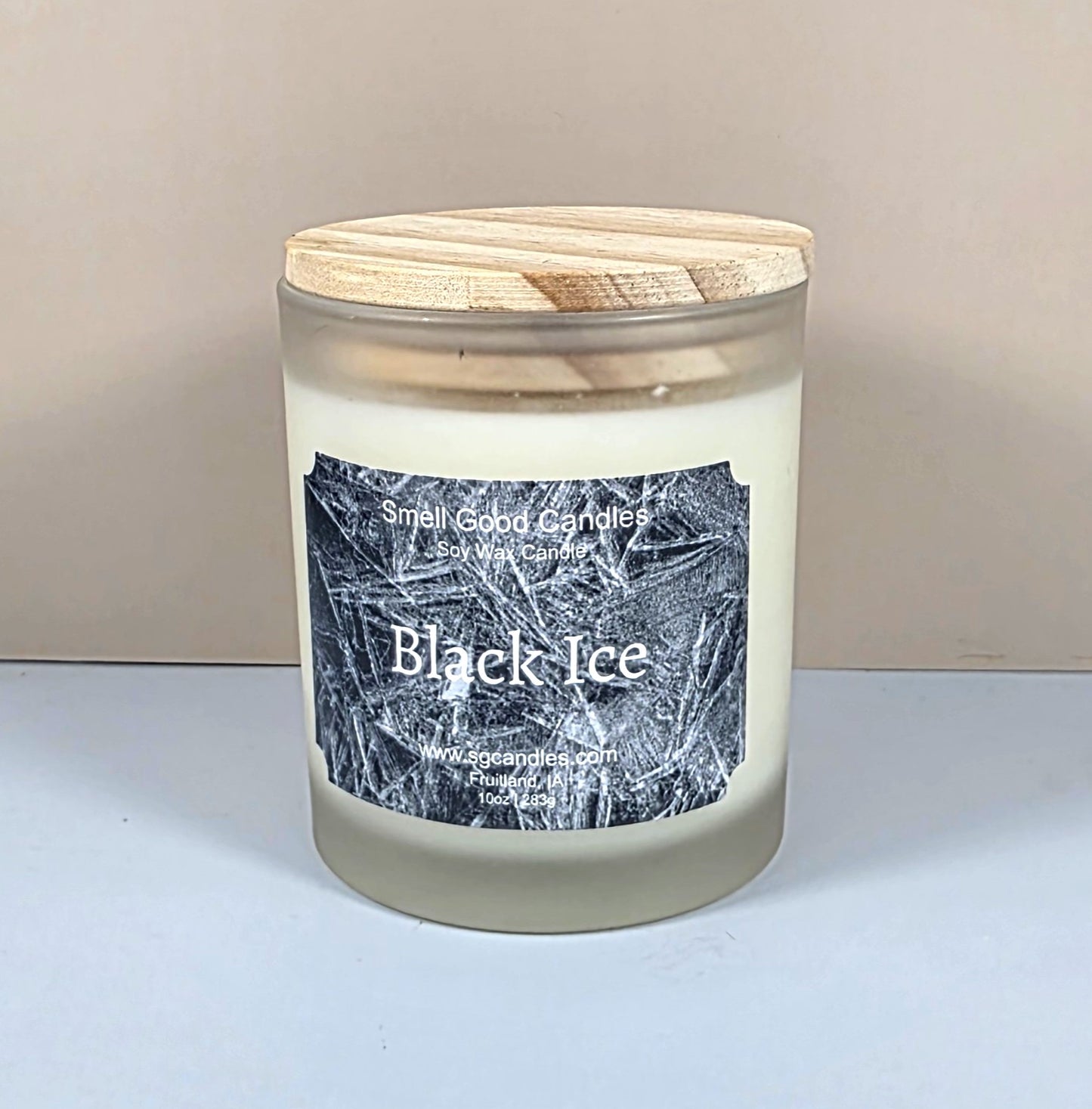 10oz glass jar candle with a black lid and a custom "Black Ice" label featuring an icy geometric mountain design