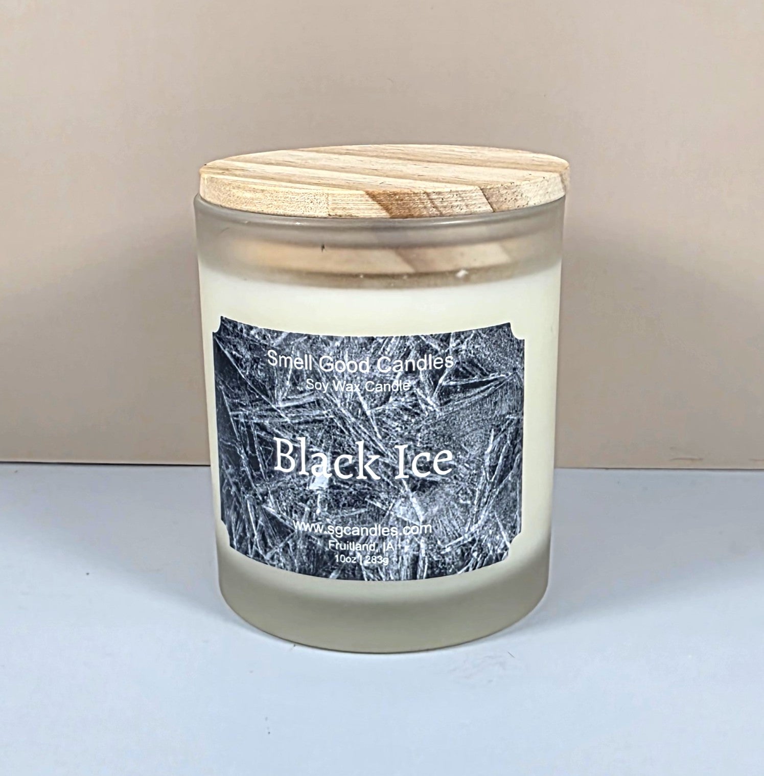 10oz glass jar candle with a black lid and a custom "Black Ice" label featuring an icy geometric mountain design