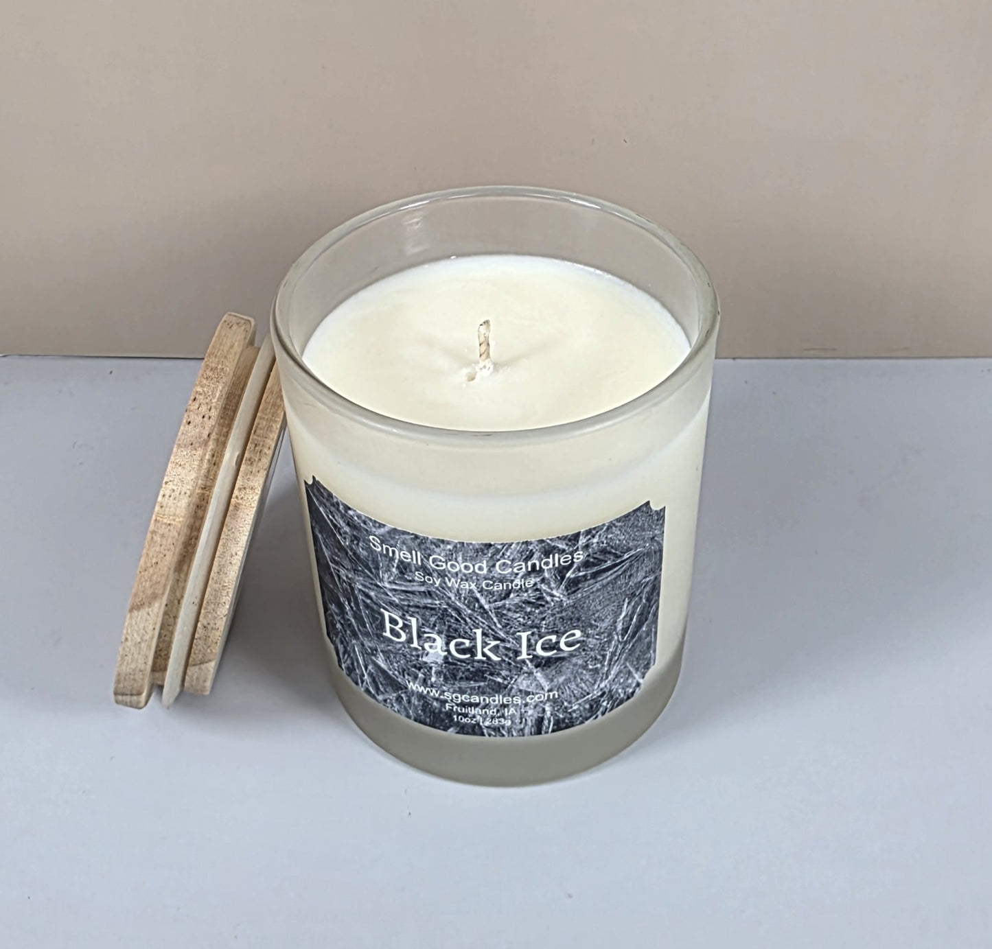 Top-down view of a hand-poured soy wax candle in a clear glass jar with a centered cotton wick