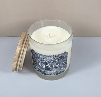 Top-down view of a hand-poured soy wax candle in a clear glass jar with a centered cotton wick