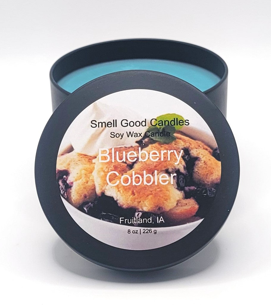 Blueberry Cobbler Soy Wax Candle - Open matte black tin showing bright teal blue dessert-scented wax