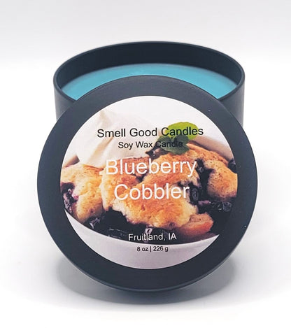 Blueberry Cobbler Soy Wax Candle - Open matte black tin showing bright teal blue dessert-scented wax
