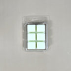 Clear 6-cavity clamshell packaging featuring off-white, hand-poured soy wax melt cubes for home fragrance warmers.