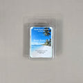 Labeled Bum Bum Sol De Janeiro soy wax melt in a 2.5oz clamshell with a vibrant beach scene and tropical palm tree imagery.