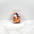 Candle wax melt package labeled 'Cinnamon Caramel' on a white surface.