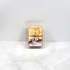 Packaged wax melt with lemon and cedarwood design on a white background