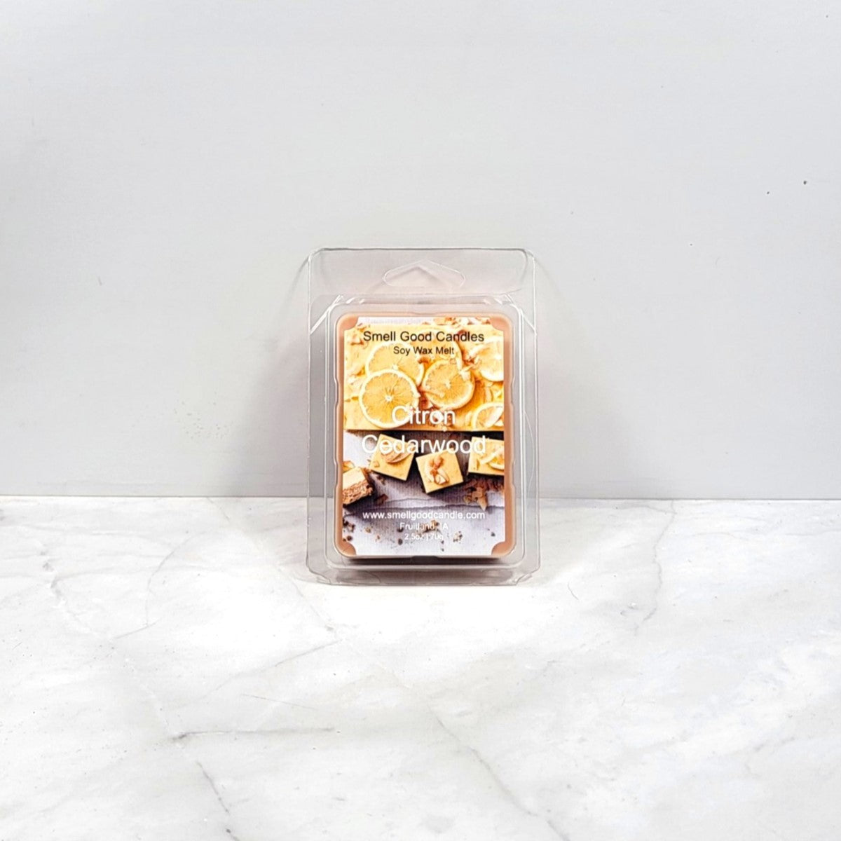 Packaged wax melt with lemon and cedarwood design on a white background