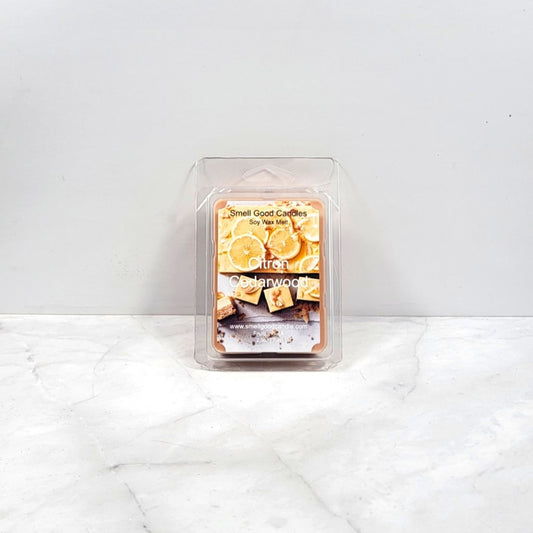 Packaged wax melt with lemon and cedarwood design on a white background