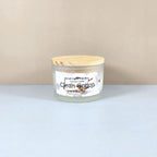 Luxury soy candle in white frosted jar, Clean Cotton scent, minimalist home decor.
