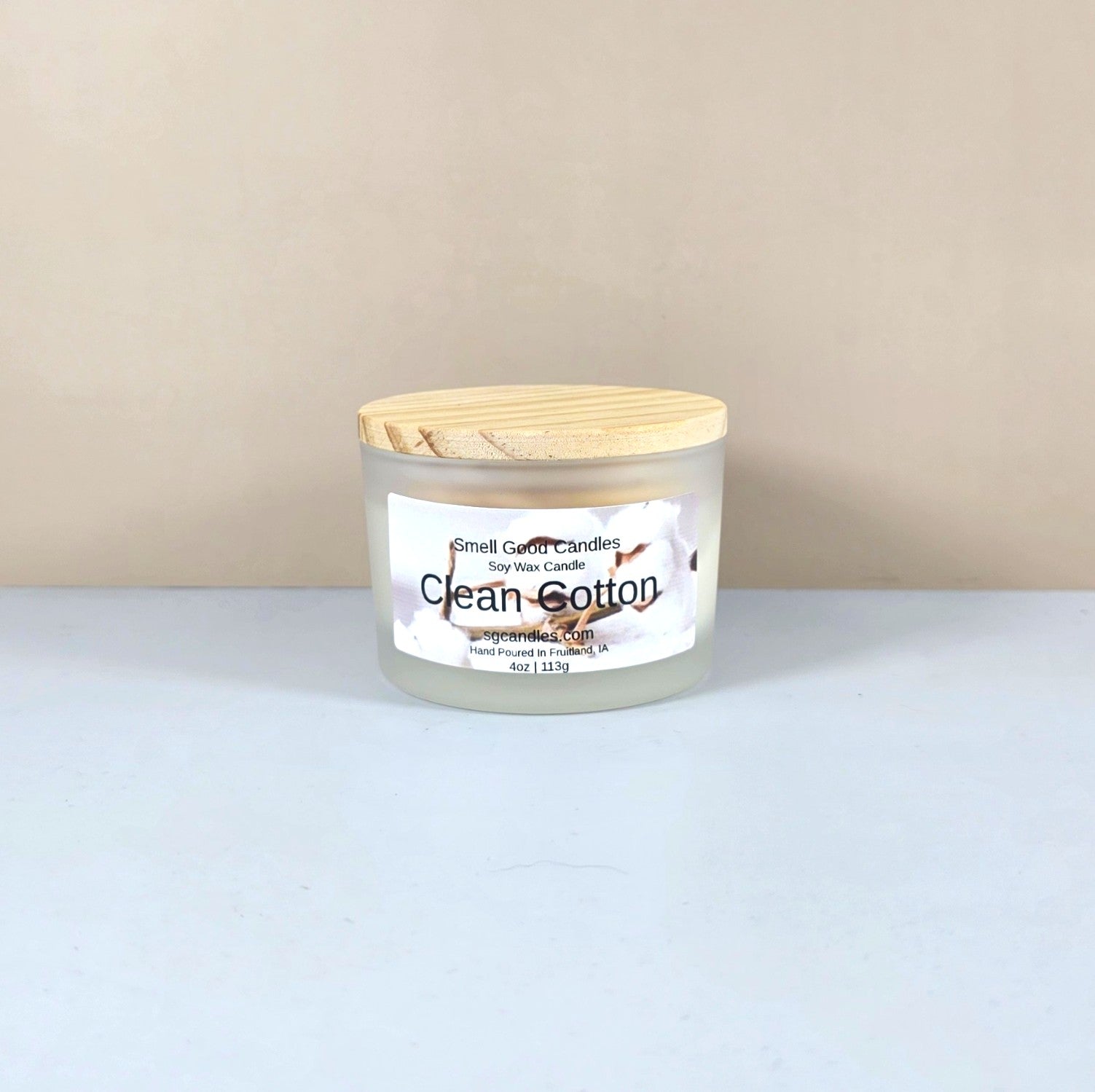 Luxury soy candle in white frosted jar, Clean Cotton scent, minimalist home decor.