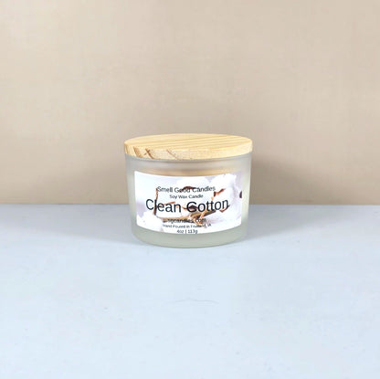 Luxury soy candle in white frosted jar, Clean Cotton scent, minimalist home decor.