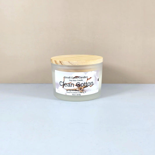 Luxury soy candle in white frosted jar, Clean Cotton scent, minimalist home decor.