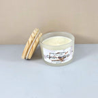 Artisanal clean cotton scented candle with wood lid, styled on a marble surface.