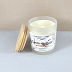 Artisanal clean cotton scented candle with wood lid, styled on a marble surface.