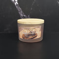 Coconut Pumpkin Latte candle with a wooden lid on a black background