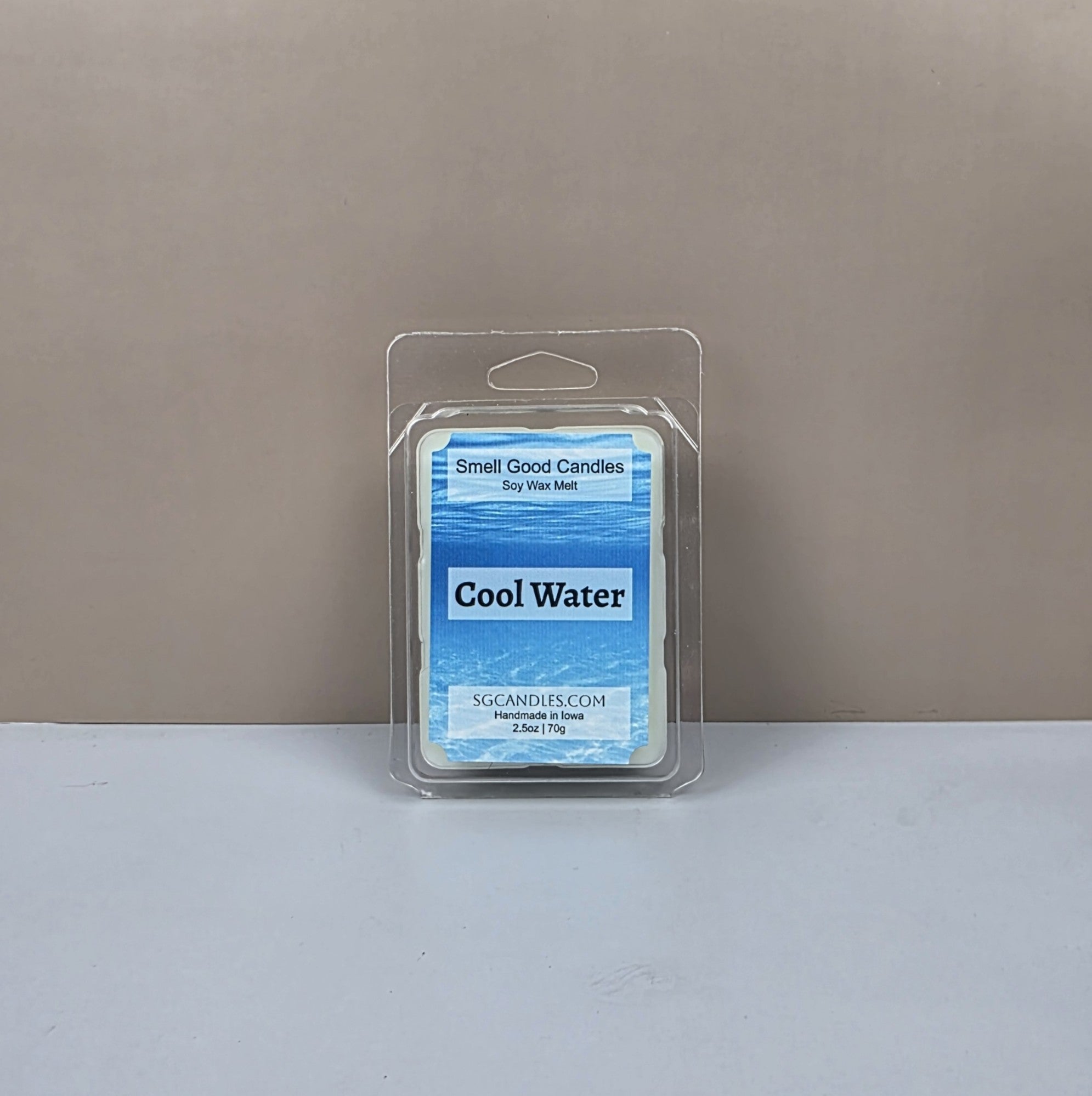 Packaged wax melt with 'Cool Water' label on a neutral background