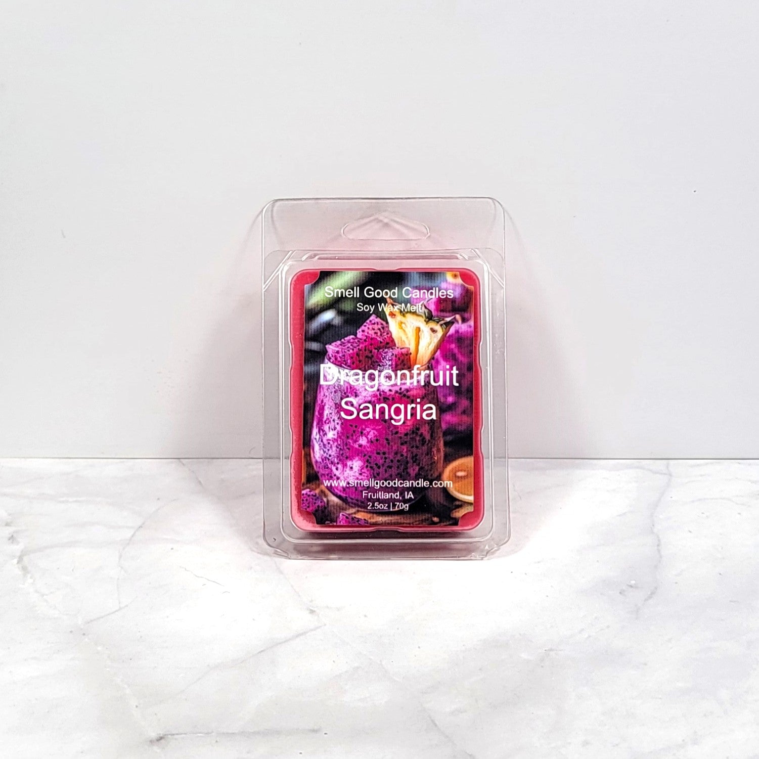 Bright-colored wax melt cubes next to a sangria glass with citrus slices