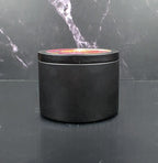 Black cylindrical container with a lid on a dark marble surface