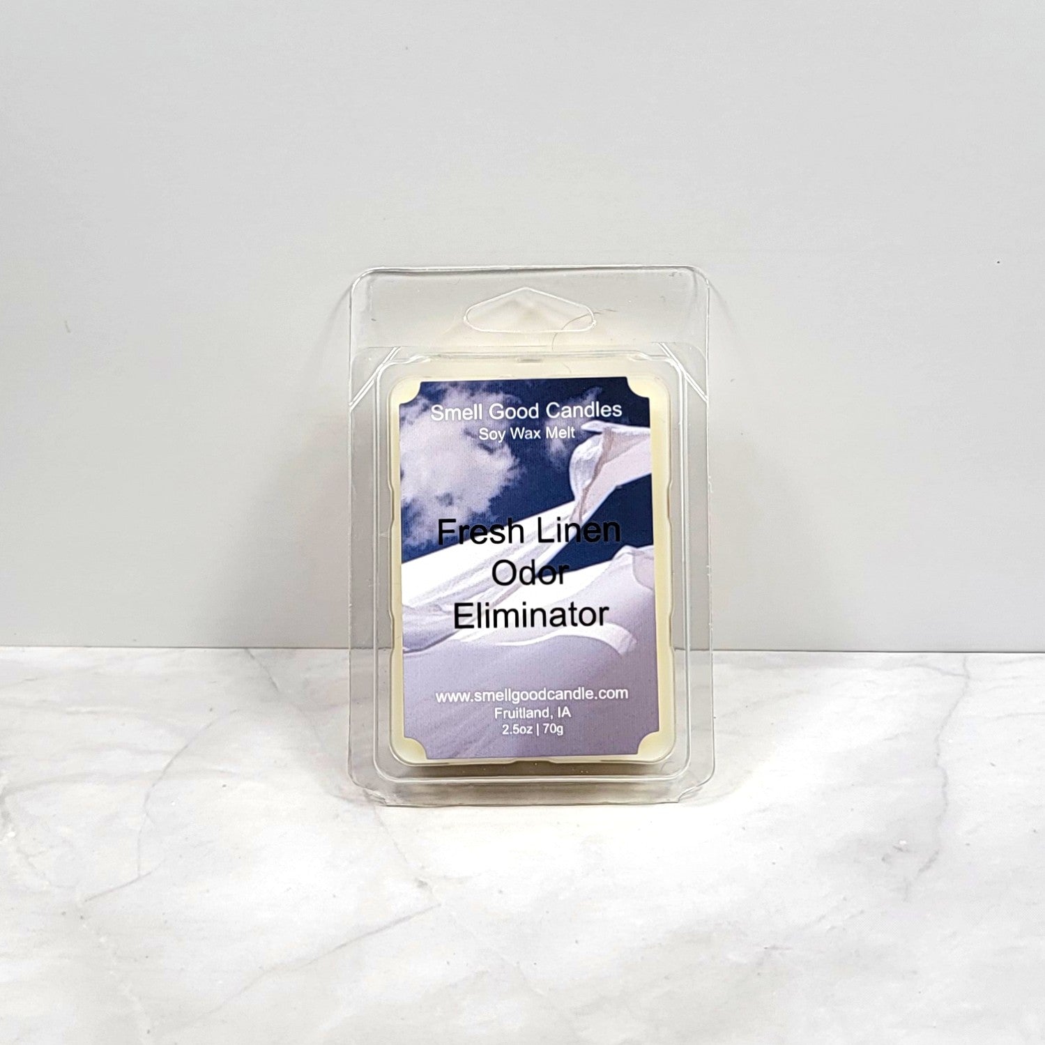 Clean white wax melt near fresh folded laundry