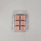 Pack of rose gold wax melts in clear packaging on a light gray background