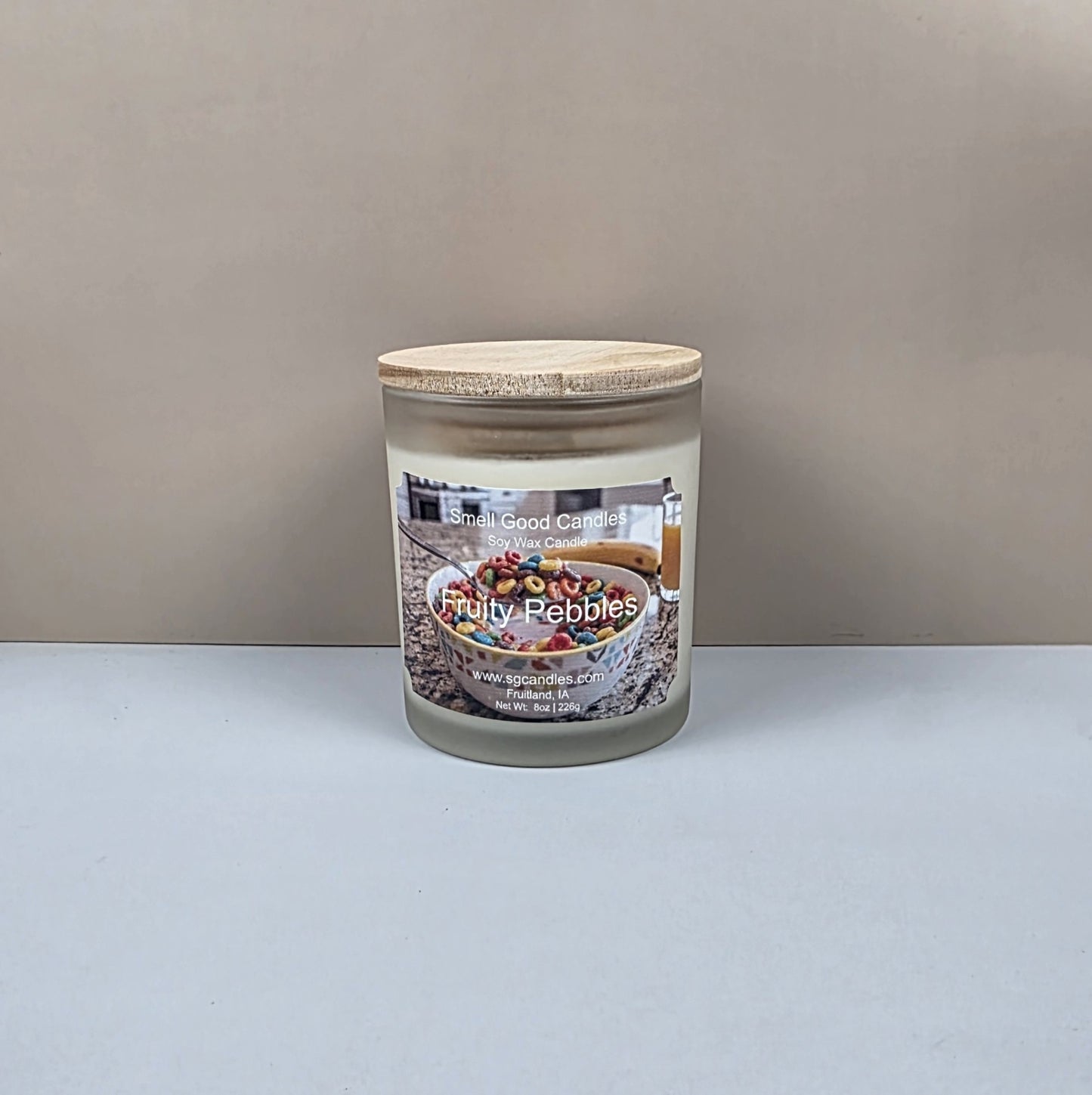 Candle jar labeled 'Fruity Pebbles' on a plain background