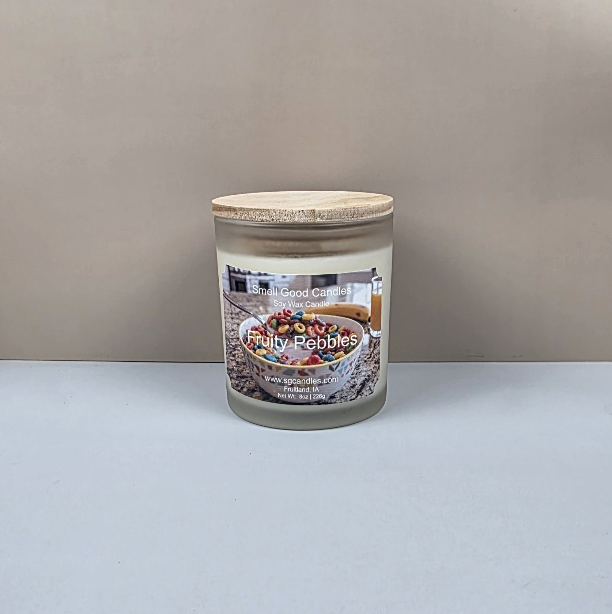 Candle jar labeled 'Fruity Pebbles' on a plain background
