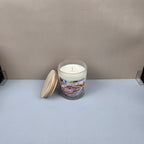 Candle with wooden lid on a white surface