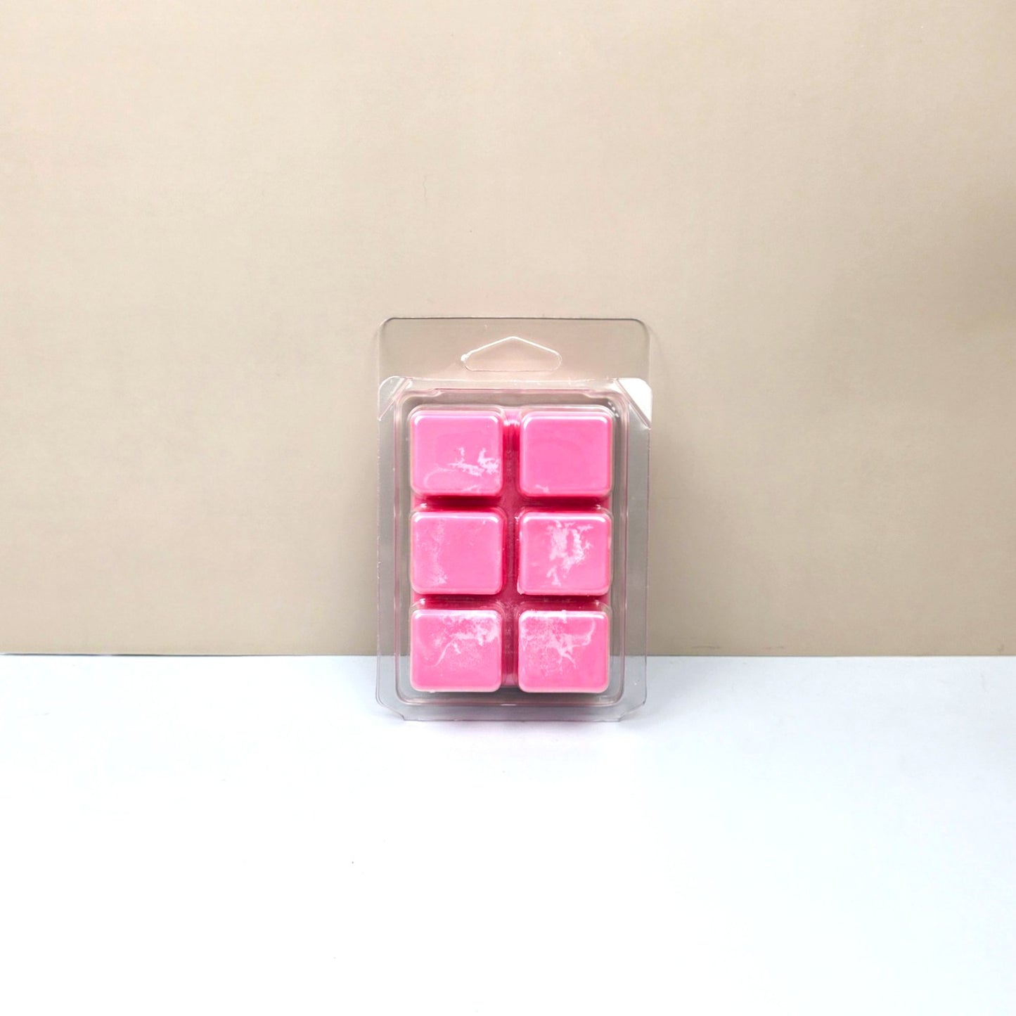Bottom view of 6-cavity wax melt clamshell showing colorful Fruity Pebbles cereal-inspired wax cubes.