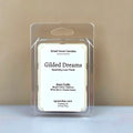Gilded Dreams luxury wax melt in a clear clamshell with a clean white label, featuring notes of Starfruit, White Birch, and Sweet Amber.