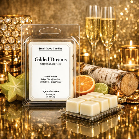 Luxury soy wax melt by Smell Good Candles featuring Gilded Dreams scent with bright citrus, starfruit, white birch, and sweet amber, shown with wax cubes and elegant gold background