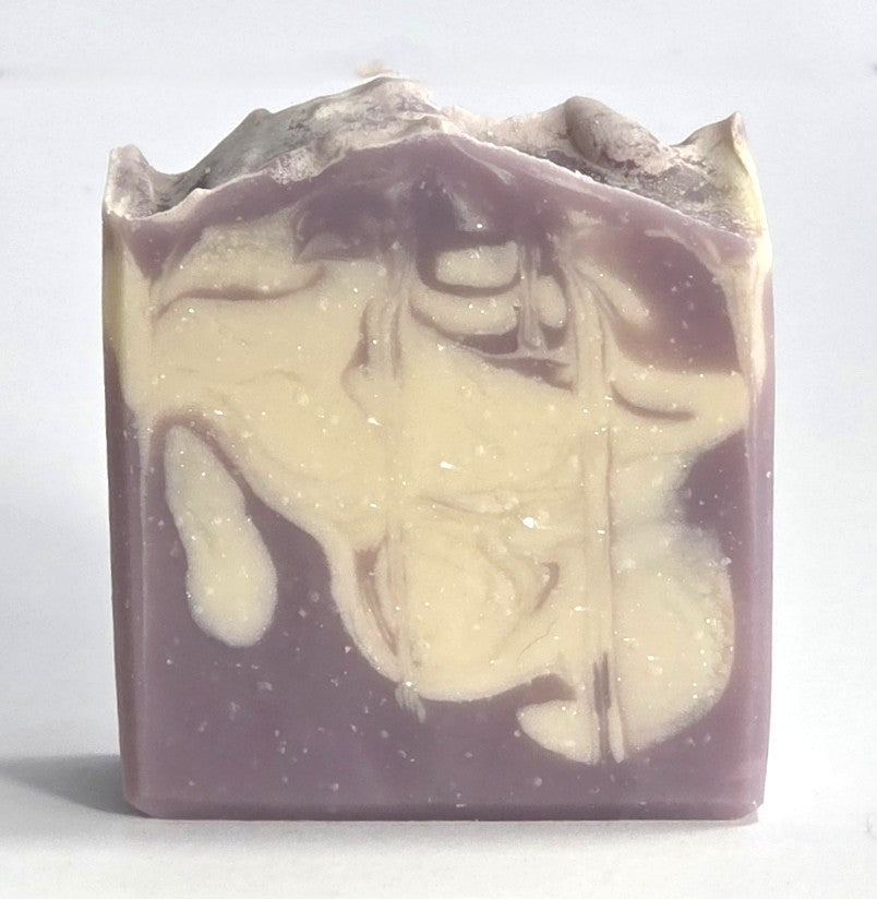 Textured top and purple and cream marbled design of a handcrafted Harvest Fig cold process soap bar.