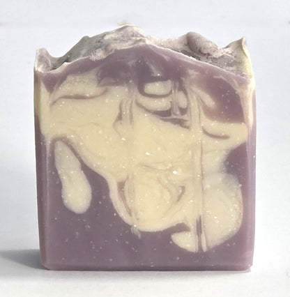 Textured top and purple and cream marbled design of a handcrafted Harvest Fig cold process soap bar.