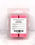 Soy wax melt cubes beside a beach towel, pineapple, and coconut