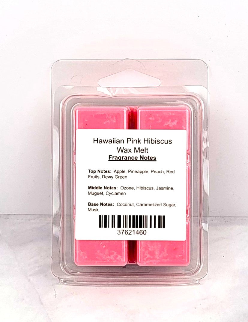 Soy wax melt cubes beside a beach towel, pineapple, and coconut