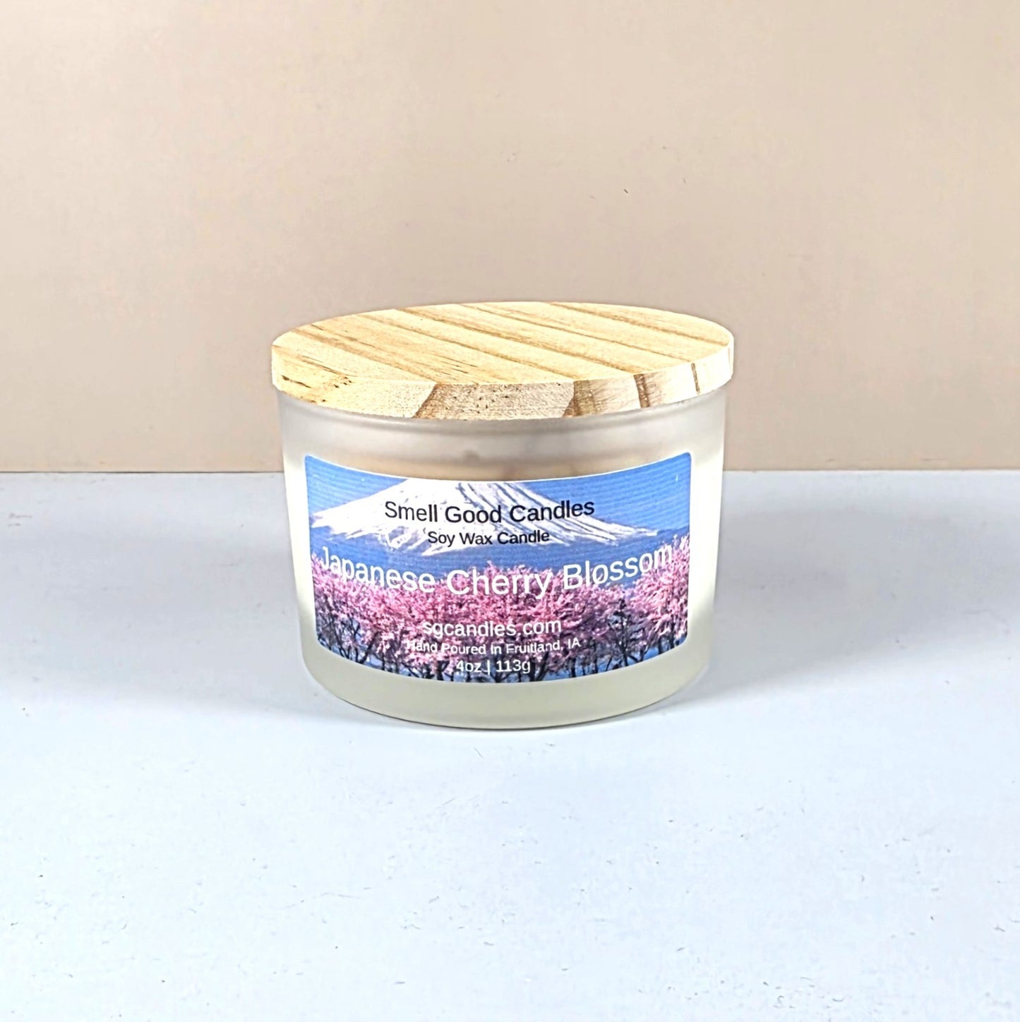 Candle with wooden lid labeled 'Japanese Cherry Blossom' on a white background