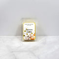 Wax melt in clear packaging with a label showing jasmine flowers and vanilla on a white background
