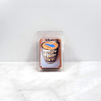 Hand-poured wax melt featuring cozy, bourbon-inspired decor