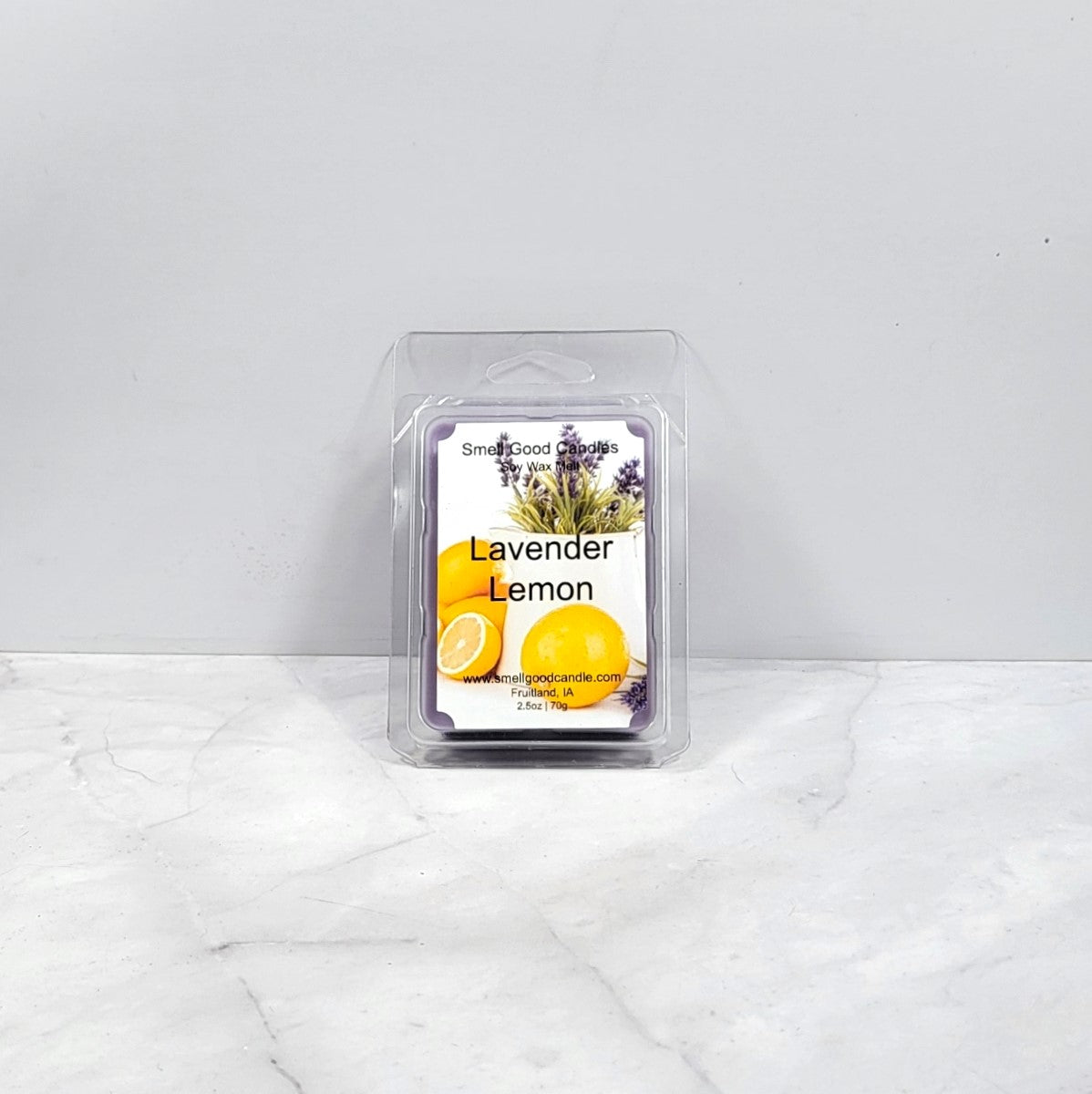 Packaged lavender lemon wax melt on a white marble surface with a light gray background